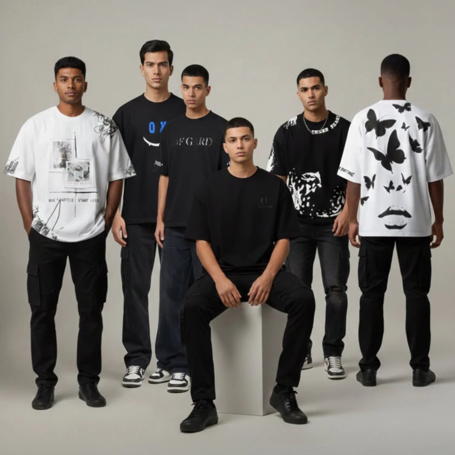 Men wearing oversized streetwear t-shirts with graphic prints and black cargo pants